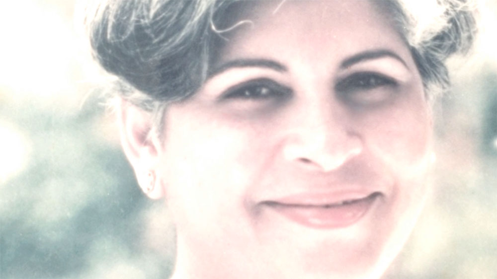 Shayan Italia’s mother smiling in a softly lit portrait featured on the About page